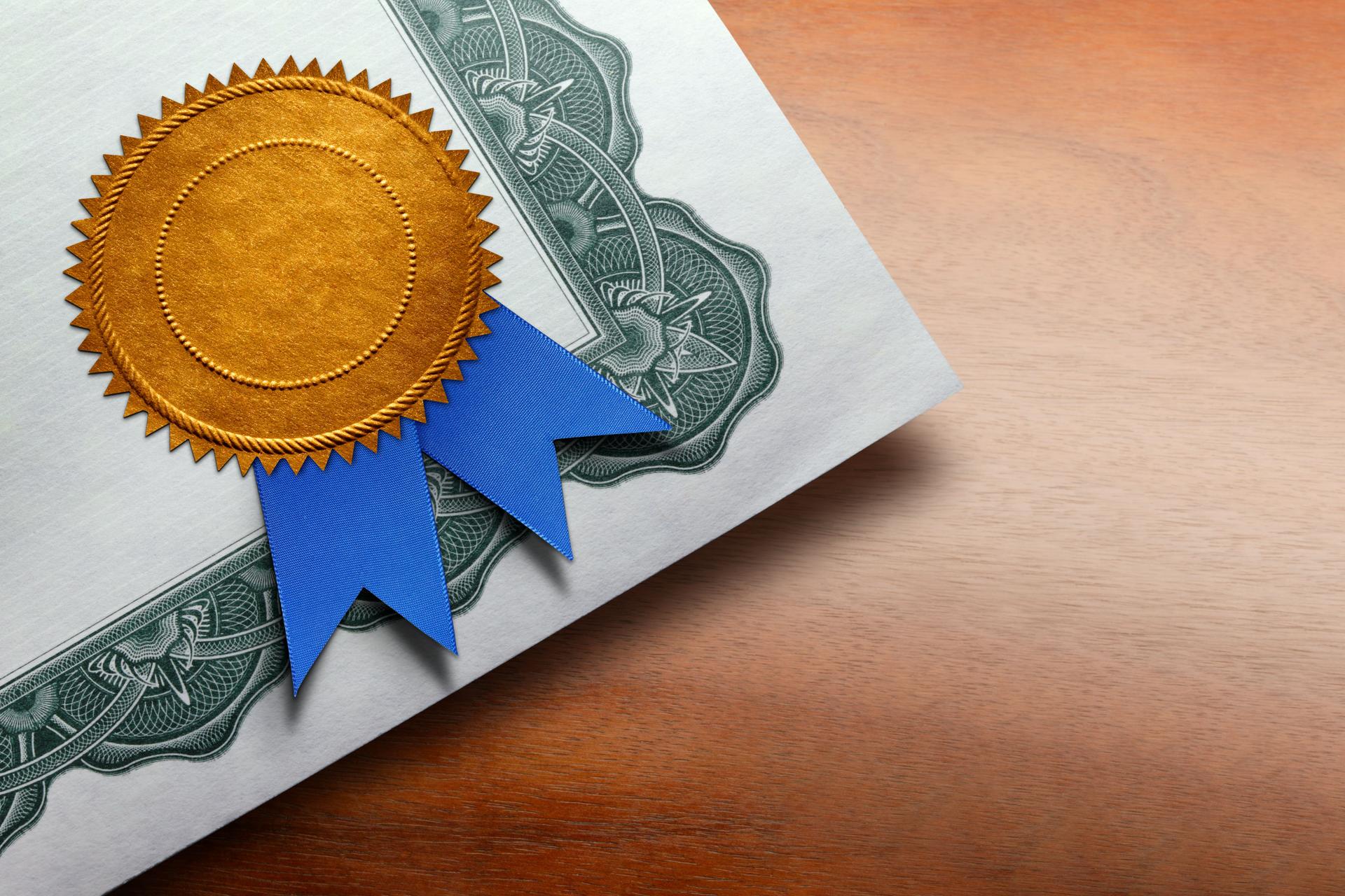 Gold Seal With Blue Ribbon On A Certificate Of Achievement